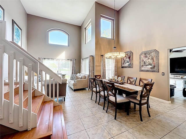 1803 Meadow Pond Way, Orlando, FL 32824 - dining area featuring a high ceiling, light tile patterned floors, plenty of natural light, and stairs