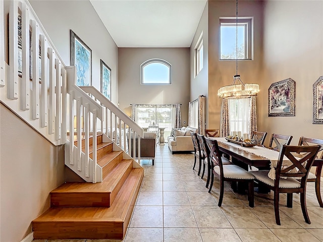1803 Meadow Pond Way, Orlando, FL 32824 - dining room with a chandelier, stairway, a towering ceiling, and light tile patterned flooring