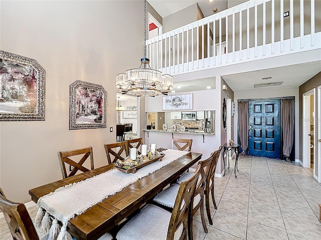 1803 Meadow Pond Way, Orlando, FL 32824 - dining room with a chandelier, a high ceiling, light tile patterned floors, and baseboards