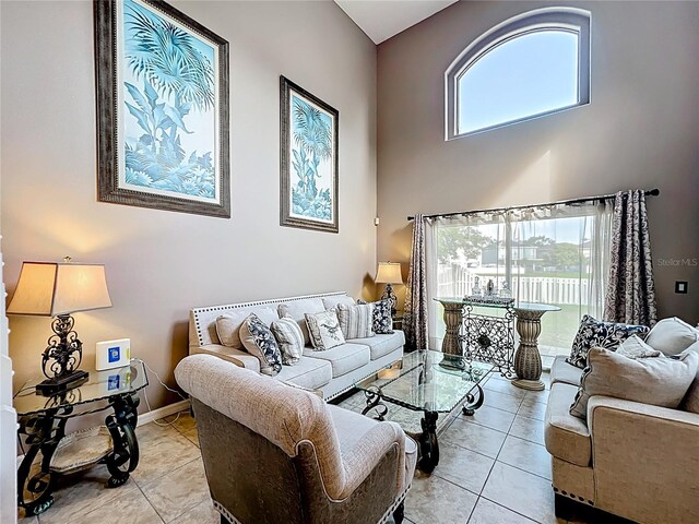 1803 Meadow Pond Way, Orlando, FL 32824 - living room with light tile patterned floors, a towering ceiling, plenty of natural light, and baseboards