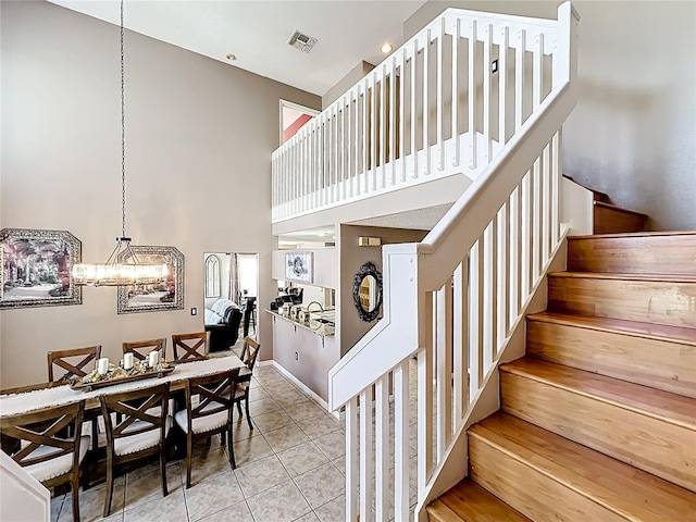 1803 Meadow Pond Way, Orlando, FL 32824 - stairway with a towering ceiling, a chandelier, and tile patterned flooring