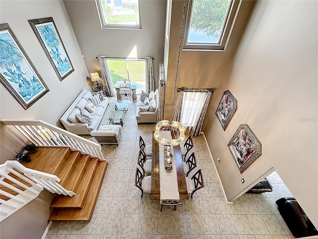 1803 Meadow Pond Way, Orlando, FL 32824 - tiled living room featuring a towering ceiling and healthy amount of natural light