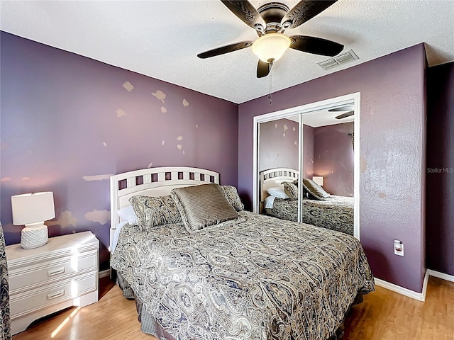 1803 Meadow Pond Way, Orlando, FL 32824 - bedroom with wood finished floors, a closet, baseboards, a textured ceiling, and a ceiling fan