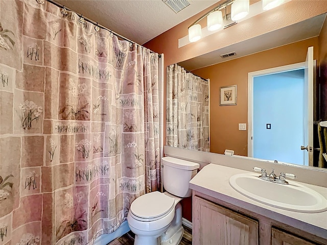 1803 Meadow Pond Way, Orlando, FL 32824 - bathroom featuring toilet, vanity, wood finished floors, curtained shower, and a textured ceiling