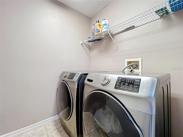 1803 Meadow Pond Way, Orlando, FL 32824 - washroom with washing machine and dryer, light tile patterned floors, baseboards, and a textured ceiling