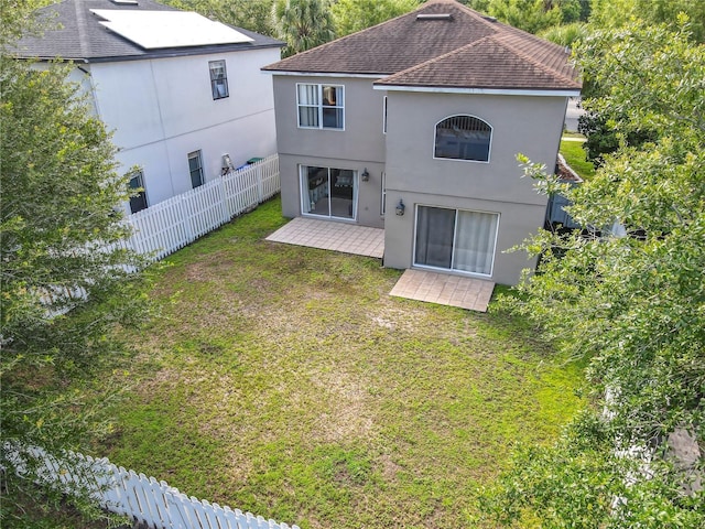 1803 Meadow Pond Way, Orlando, FL 32824 - rear view of house with roof with shingles, stucco siding, and a patio area