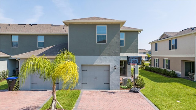 13452 Sagestone Dr, Winter Garden, FL 34787 - view of front of house with a garage, stucco siding, and decorative driveway