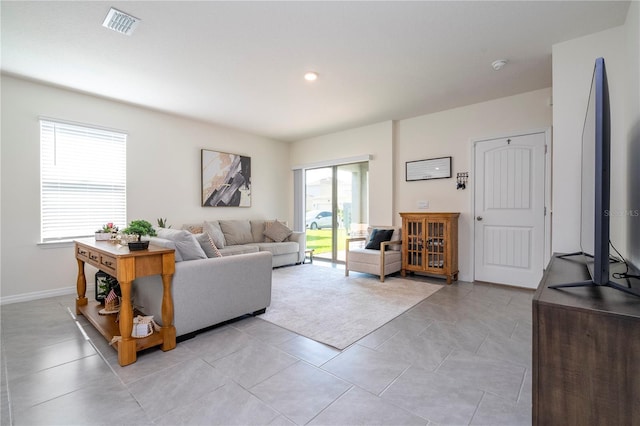 13452 Sagestone Dr, Winter Garden, FL 34787 - living room featuring baseboards and light tile patterned flooring