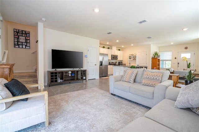 13452 Sagestone Dr, Winter Garden, FL 34787 - living room with recessed lighting, light tile patterned flooring, stairway, and baseboards