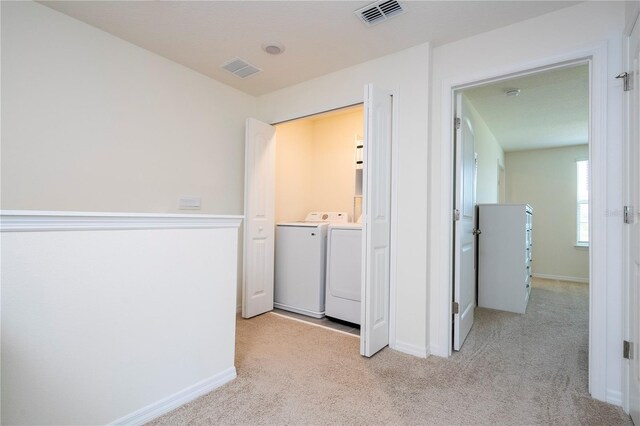 13452 Sagestone Dr, Winter Garden, FL 34787 - corridor with washer and dryer, light colored carpet, and baseboards