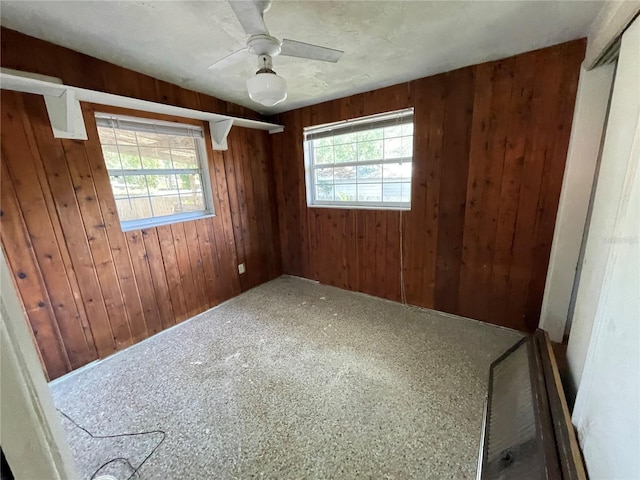 432 2nd Ave NE, Largo, FL 33770 - carpeted empty room with wood walls and ceiling fan