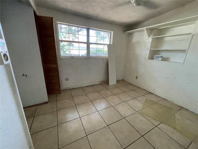 432 2nd Ave NE, Largo, FL 33770 - empty room with light tile patterned flooring and a textured ceiling