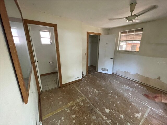 432 2nd Ave NE, Largo, FL 33770 - unfurnished bedroom featuring ensuite bath and baseboards