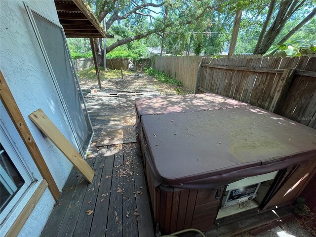 432 2nd Ave NE, Largo, FL 33770 - wooden deck featuring a fenced backyard and a hot tub