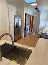 1422 Spalding Rd, Winter Springs, FL 32708 - kitchen featuring a sink, stainless steel refrigerator with ice dispenser, white cabinets, and light countertops