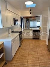1422 Spalding Rd, Winter Springs, FL 32708 - kitchen with appliances with stainless steel finishes, light tile patterned flooring, plenty of natural light, and light countertops