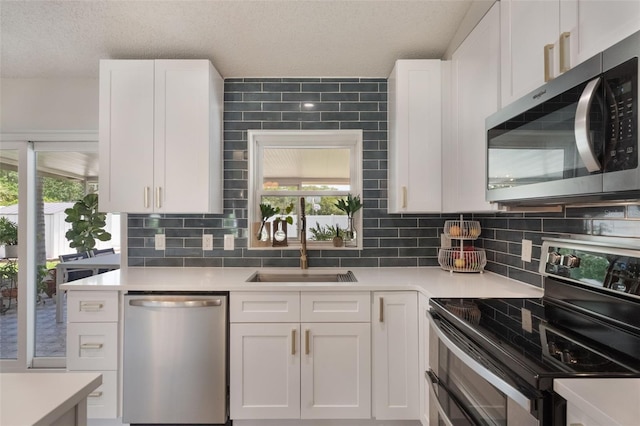 719 Stevelynn Cir, Winter Garden, FL 34787 - kitchen with appliances with stainless steel finishes, white cabinets, light countertops, and a textured ceiling