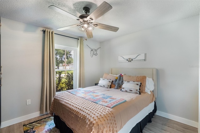 719 Stevelynn Cir, Winter Garden, FL 34787 - bedroom featuring baseboards, wood finished floors, ceiling fan, and a textured ceiling