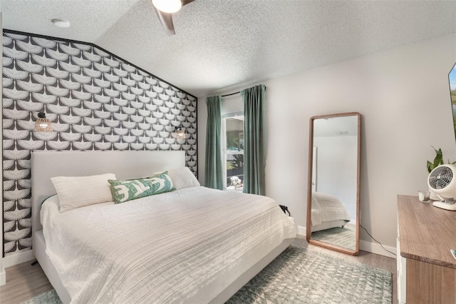719 Stevelynn Cir, Winter Garden, FL 34787 - bedroom featuring wood finished floors, vaulted ceiling, a textured ceiling, and baseboards