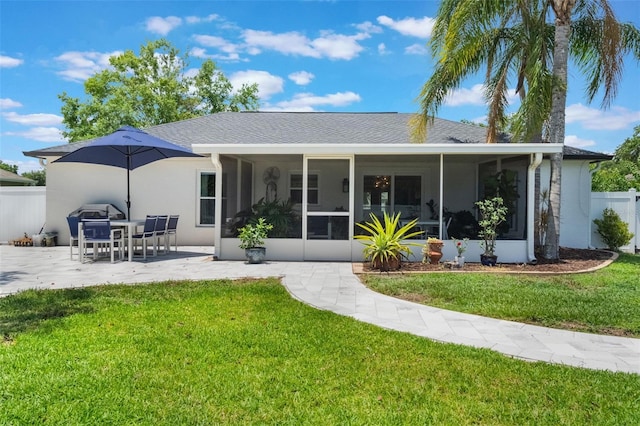719 Stevelynn Cir, Winter Garden, FL 34787 - rear view of house featuring a sunroom, a patio, stucco siding, and a shingled roof