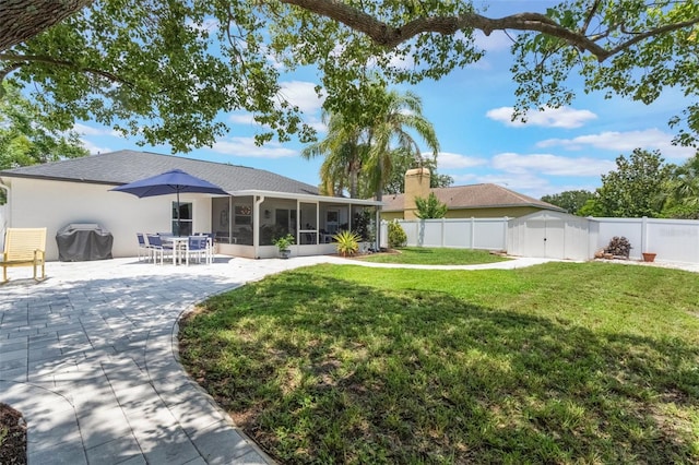 719 Stevelynn Cir, Winter Garden, FL 34787 - rear view of house featuring a sunroom, a chimney, a patio area, and stucco siding