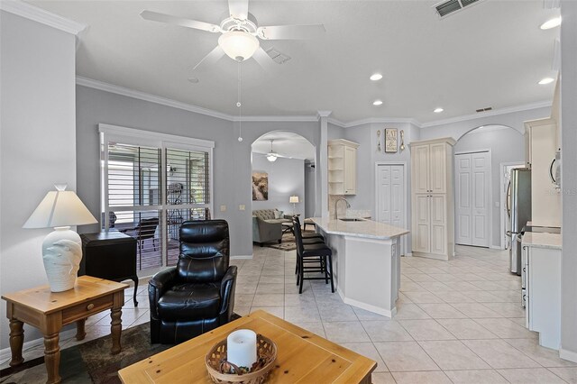 1124 Hidden Blf, Clermont, FL 34711 - living room featuring arched walkways, a ceiling fan, light tile patterned floors, crown molding, and recessed lighting