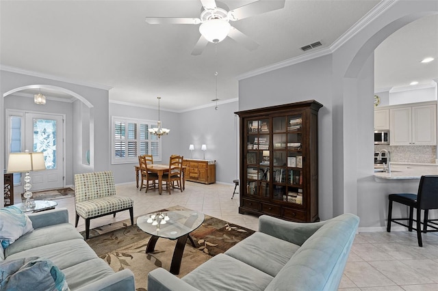 1124 Hidden Blf, Clermont, FL 34711 - living room featuring arched walkways, light tile patterned floors, ornamental molding, ceiling fan, and baseboards