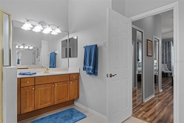 1124 Hidden Blf, Clermont, FL 34711 - full bathroom featuring ensuite bath, vanity, tile patterned floors, and baseboards