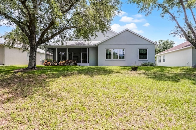 1124 Hidden Blf, Clermont, FL 34711 - rear view of property featuring a sunroom, a yard, and stucco siding