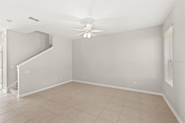 7715 Anselmo Ln, Windermere, FL 34786 - spare room with a ceiling fan, stairway, plenty of natural light, and baseboards