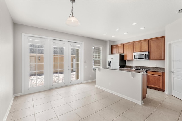 7715 Anselmo Ln, Windermere, FL 34786 - kitchen with appliances with stainless steel finishes, brown cabinets, baseboards, recessed lighting, and decorative light fixtures