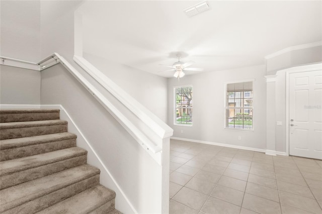 7715 Anselmo Ln, Windermere, FL 34786 - staircase with tile patterned flooring, a ceiling fan, and baseboards