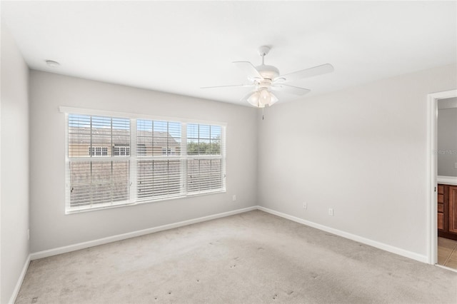 7715 Anselmo Ln, Windermere, FL 34786 - unfurnished bedroom with carpet flooring, baseboards, ceiling fan, and connected bathroom