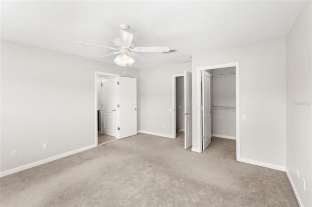 7715 Anselmo Ln, Windermere, FL 34786 - unfurnished bedroom with light carpet, baseboards, a walk in closet, ceiling fan, and a closet