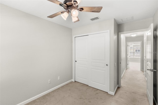 7715 Anselmo Ln, Windermere, FL 34786 - unfurnished bedroom with light colored carpet, baseboards, a closet, and a ceiling fan