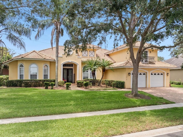 1319 Johns Cove Ln, Oakland, FL 34787 - mediterranean / spanish house featuring french doors, stucco siding, driveway, and a front yard