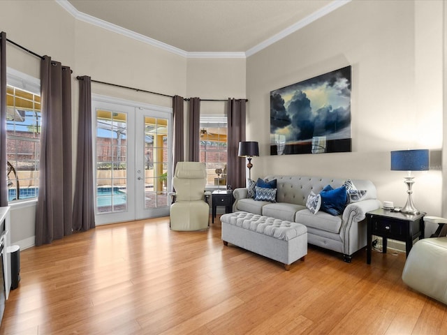 1319 Johns Cove Ln, Oakland, FL 34787 - living room featuring french doors, ornamental molding, and light wood-type flooring