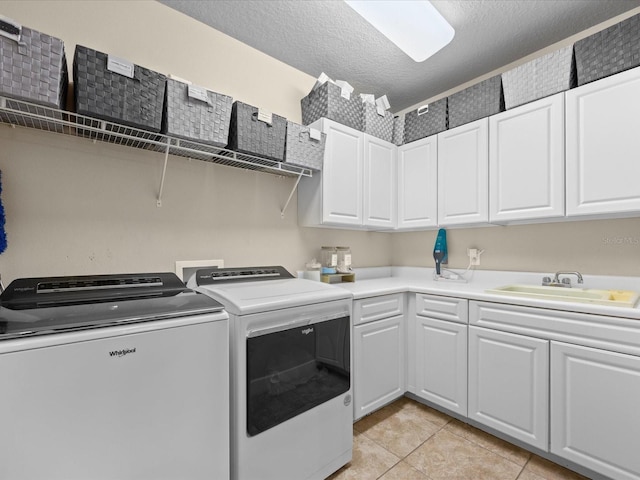 1319 Johns Cove Ln, Oakland, FL 34787 - washroom with washer and clothes dryer, light tile patterned flooring, cabinet space, and a textured ceiling