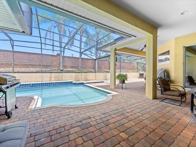 1319 Johns Cove Ln, Oakland, FL 34787 - view of pool featuring glass enclosure, a patio, ceiling fan, and a grill