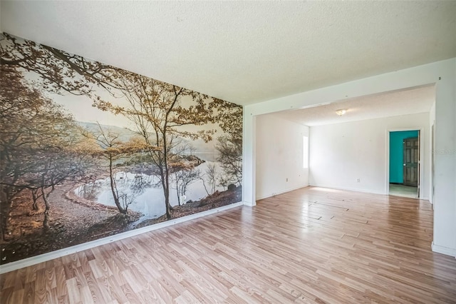 1601 Randolph St, Deltona, FL 32725 - unfurnished room with wood finished floors, a textured ceiling, and baseboards