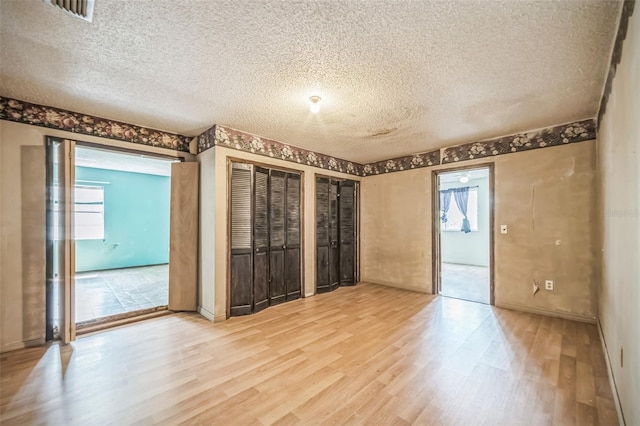 1601 Randolph St, Deltona, FL 32725 - spare room with light wood finished floors, a textured ceiling, plenty of natural light, and baseboards
