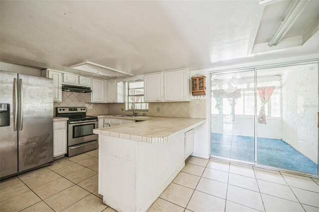 1601 Randolph St, Deltona, FL 32725 - kitchen featuring stainless steel appliances, under cabinet range hood, a peninsula, a sink, and white cabinetry