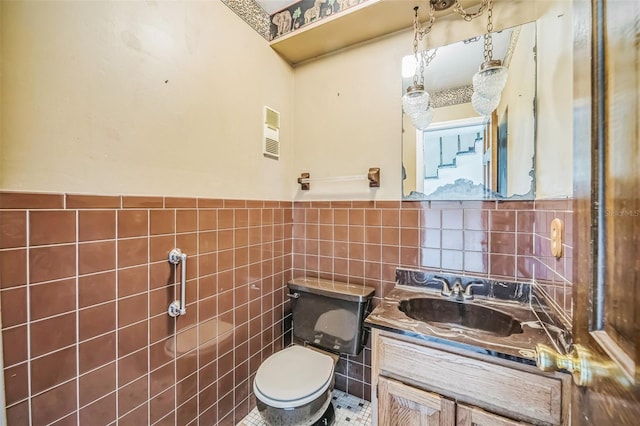 1601 Randolph St, Deltona, FL 32725 - bathroom with tile walls, toilet, vanity, and wainscoting