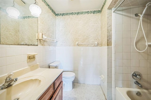 1601 Randolph St, Deltona, FL 32725 - bathroom featuring tile walls, vanity, tile patterned flooring, toilet, and washtub / shower combination
