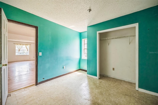 1601 Randolph St, Deltona, FL 32725 - unfurnished bedroom with a textured ceiling, baseboards, and a closet