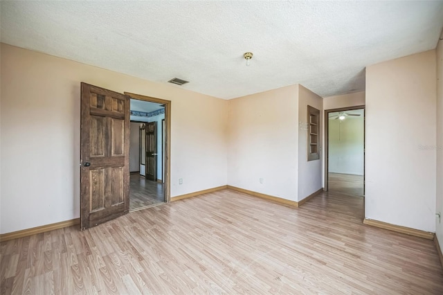 1601 Randolph St, Deltona, FL 32725 - spare room with light wood-type flooring, baseboards, and a textured ceiling