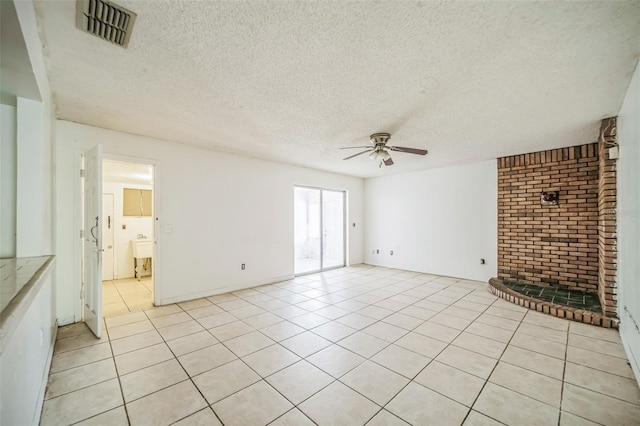 1601 Randolph St, Deltona, FL 32725 - unfurnished living room featuring ceiling fan, a textured ceiling, brick wall, light tile patterned floors, and a sink
