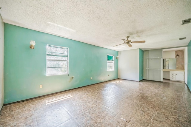 1601 Randolph St, Deltona, FL 32725 - unfurnished room with ceiling fan, a textured ceiling, and baseboards