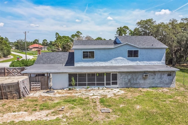 1601 Randolph St, Deltona, FL 32725 - rear view of property with stucco siding and a sunroom