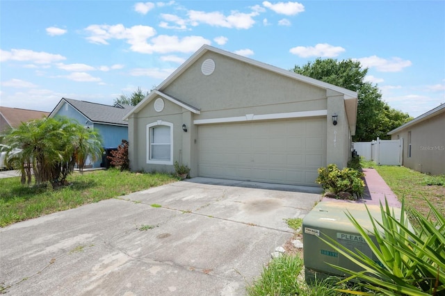 8141 Golden Chickasaw Cir, Orlando, FL 32825 - ranch-style home featuring driveway, an attached garage, stucco siding, and a gate